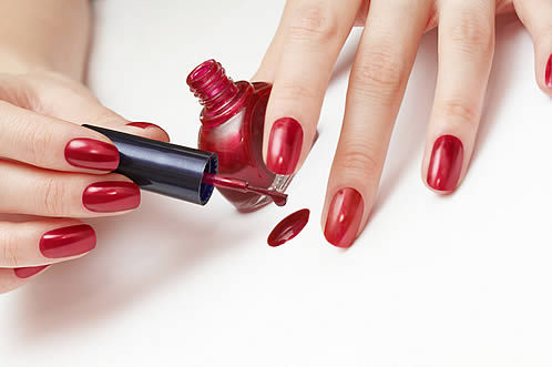 red-nails-with-nail-polish-dripping